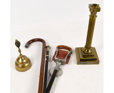 A silver mounted ebonised walking cane, Chester 1920, a white metal mounted example, a shooting stick, a brass bell and a Cor