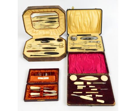 An early 20th century bone handled manicure set in a fitted box including toothbrush and rouge pots, a small matched example 