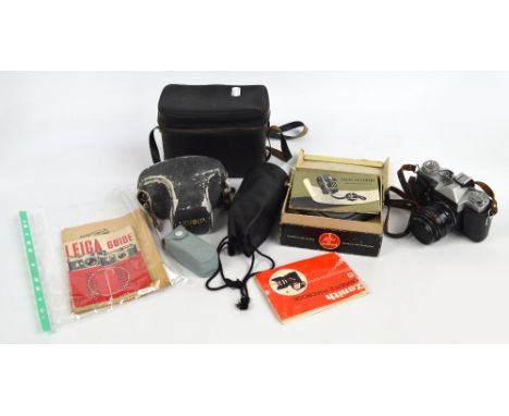 A Minolta XG-1, a Zenit-E, a Bolex C8 camera, a lens and two Leica camera guides.