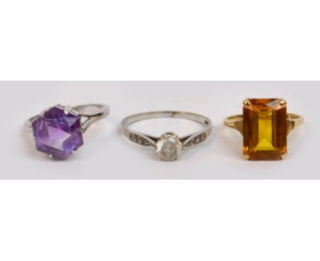 Three 9ct gold dress rings including a white gold example set with an amethyst coloured hexagonal cut claw set stone.