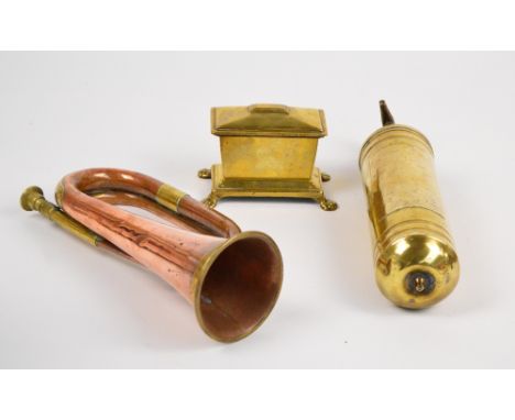A copper and brass bugle, length 30.5cm, a small sarcophagus shaped brass tobacco box raised on four paw feet, and a brass ex