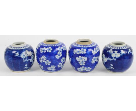 A pair of early 20th century Chinese porcelain ginger jars, painted in underglaze blue with blossoming prunus on a cracked ic