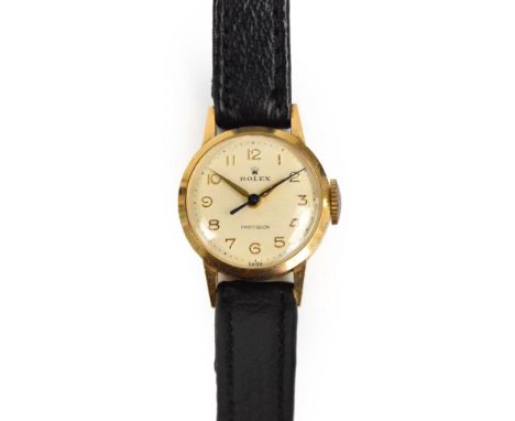 ROLEX; a 9ct gold cased lady's wristwatch, the cream dial bearing Arabic numerals and inscribed "Rolex Precision", on leather