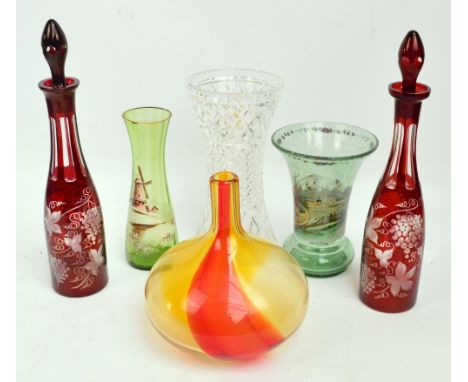A large cut glass vase, a near pair of Bohemian ruby tinted and edged glass decanters with stoppers, a green glass vase decor