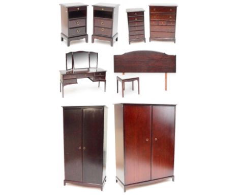 An eight piece Stag Minstrel bedroom suite, comprising tall wardrobe, two door wardrobe, dressing table, tallboy, pair of bed