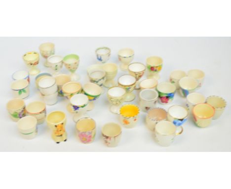 A collection of largely hand painted egg cups including examples by Tuscan, Paragon, Poole, Foley, Ridgeways, Burleigh, Carlt