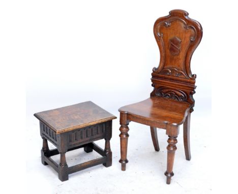 A Victorian carved oak hall chair with shield shaped back on ring turned front legs and a reproduction carved oak box seat st