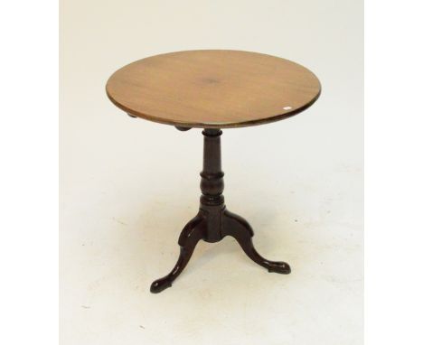 A Georgian mahogany tilt top occasional table with circular top above a birdcage action and turned central column on tripod b