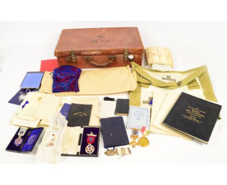 A small leather case containing various Masonic regalia including a 9ct gold jewel, three silver jewels, a circular jewel, va