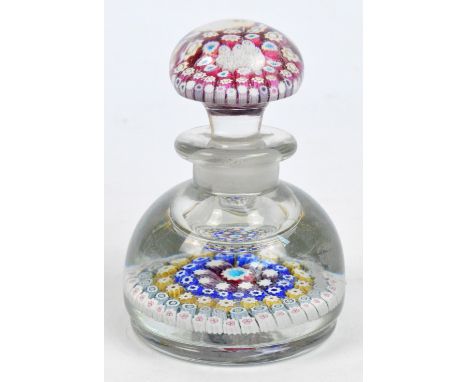 An early 20th century glass inkwell paperweight, the mushroom stopper decorated with numerous canes above a similarly domed b