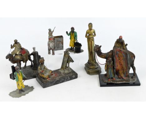 In the manner of FRANZ BERGMANN; novelty table lighters, one modelled as a man astride a camel, another depicting a rug selle