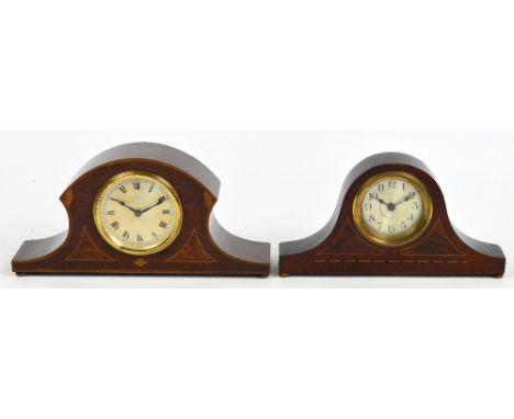 An Edwardian mahogany mantel timepiece with shaped top and inlaid front, the silvered circular dial set with Roman numerals, 