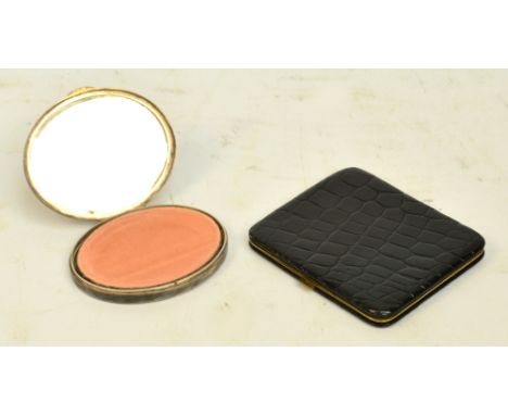 An early 20th century French white metal oval compact by Marcel Rochas engraved with foliate decoration to the exterior, widt