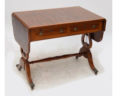 A late 19th century mahogany crossbanded sofa table with shaped leaves, two drawers, lyre supports to tapering square legs an