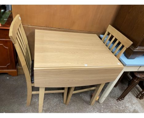 LIGHT OAK DROP FLAP DINING TABLE AND PAIR OF SLAT BACK CHAIRS