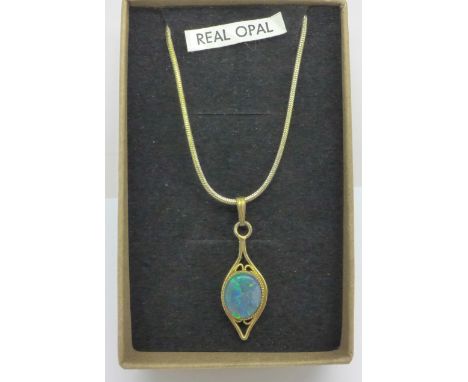 An opal pendant on a silver gilt chain 