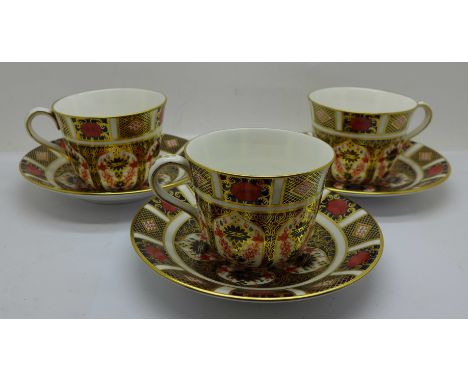 Three Royal Crown Derby 1128 pattern cups and saucers 