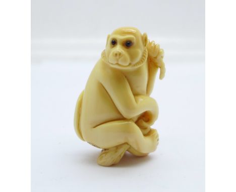 A carved ivory Japanese monkey netsuke, signed 