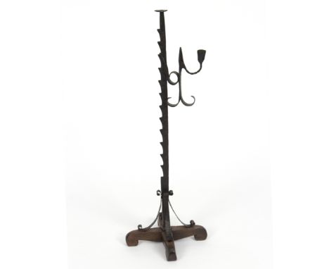 An iron floor standing adjustable rush light holder, on cruciform base, 80cm high 