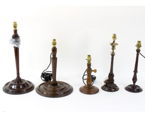 Two George III fluted mahogany candlesticks, converted for electricity, another wooden table lamp and two large turned wood t