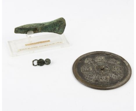 A bronze axe head, a Chinese metal mirror, a small buckle and another   Condition Report:  Axe head covered in Verdigris.  Bu