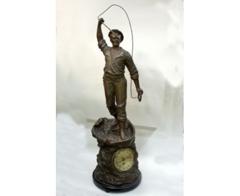 An eight-day mantel clock the spelter case surmounted by a fisherman with harpoon, another spelter figure, etc./Provenance: T