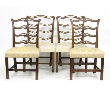 Four 19th Century mahogany dining chairs, each with wavy pierced ladder supports and overstuffed seats in cream damask (two s