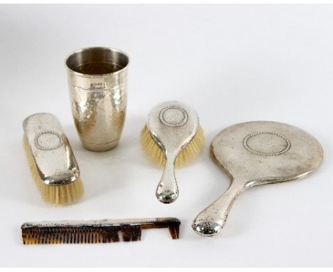 A Danish silver beaker, assay master Christian F Heise, with hammered finish, dated to collar, 13cm high and a four-piece dre