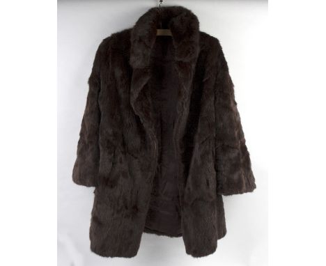 A black astrakhan and mink fur coat, a mid-length dark brown mink fur coat and another brown mink fur coat