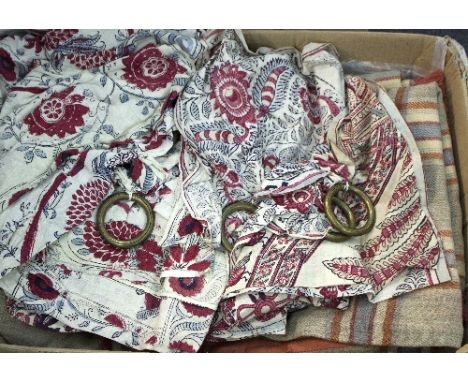 Various curtains, curtain hooks and a patchwork quilt