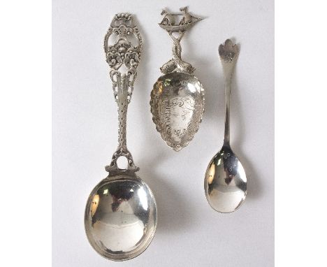 A silver caddy spoon, import marks T H, London 1901, with ship and entwined dolphin handle, an 830 standard spoon and a trefo