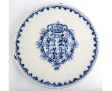 A Spanish faience blue and white charger painted with the Royal Coat of Arms, late 18th Century, 39cm diameter/Provenance: Tr