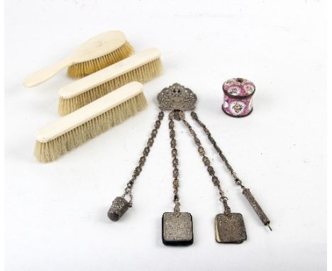 A plated chatelaine with pierced and embossed decoration, an enamel ink pot and a three-piece dressing set/Provenance: Treago