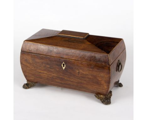 A Regency rosewood sarcophagus shaped tea caddy with fitted interior, on lion paw feet