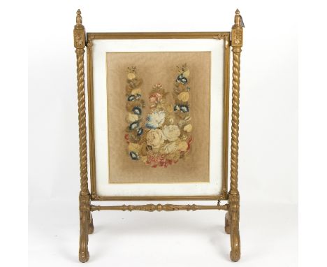 A needlework firescreen on spiral supports/Provenance: The Down House, Redmarley