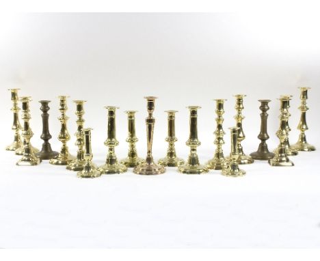 Eight pairs of 19th Century brass candlesticks, various forms, 26cm high and smaller, a single stick and a 20th Century pair 