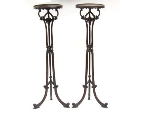 A pair of Chippendale style mahogany torchères, the circular tops on scrolling columns and tripod bases, 116cm high Condition