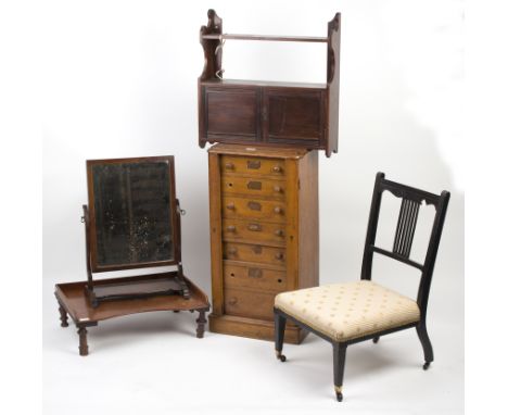 An oak Wellington type chest of seven drawers, 43cm wide, an ebonised Edwardian chair, a hanging shelf, bedside table etc./Pr