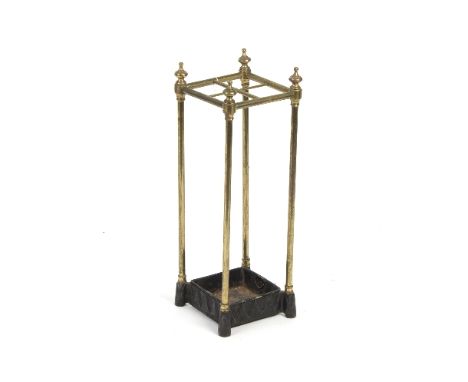 A brass stick stand of four divisions with finials to the corners, 62cm high