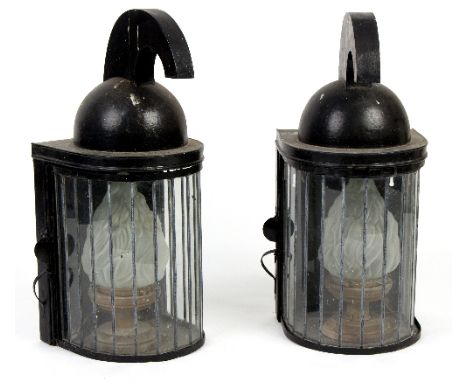 A pair of black painted half-round lanterns with flame opaque shades and helmet type finials, 67cm high/Provenance: The Down 