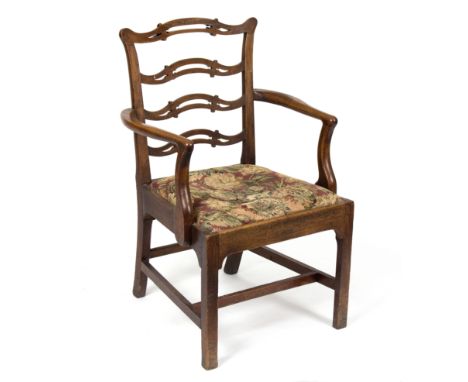 A George III style open armchair, with pierced ladder back and trap seat 