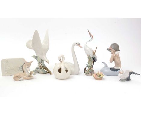 A group of Lladro and Nao figurines, comprising: a Lladro figure of a dove; a Lladro swan; a Lladro crane; a Lladro donkey; a