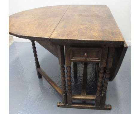 17TH CENTURY OAK OVAL DOUBLE GATE ACTION DROP LEAF DINING TABLE, moulded drawers to both ends, on bobbin turned legs with scr