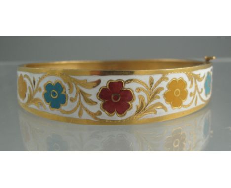 UNMARKED YELLOW GOLD BANGLE decorated in red, yellow , blue and white enamel with flowers and scrolling foliage. Pull out pin