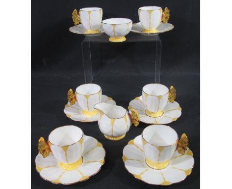 FOURTEEN PIECE AYNSLEY PORCELAIN TEA SERVICE of fluted form with yellow decoration and butterfly handles with gilded rims to 