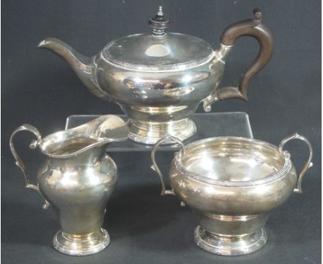 SILVER THREE PIECE TEA SERVICE, the teapot of baluster form with matching two handled sucrier and helmet shaped cream jug, al