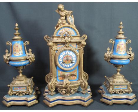 19TH CENTURY FRENCH GILT METAL CLASSICALLY DESIGN CLOCK GARNITURE, the clock surmounted by cherub and decorated with inset pa