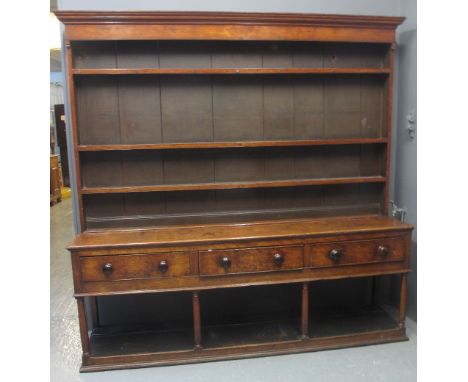 19TH CENTURY WELSH OAK POTBOARD DRESSER having boarded three shelf rackback with moulded cornice, the base with three cock be