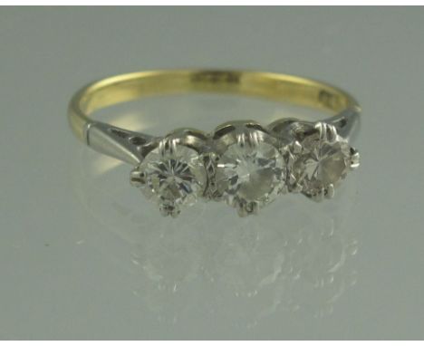 18CT GOLD THREE STONE DIAMOND RING. The three brilliant cut diamonds an estimated total diamond weight of 0.67cts. Ring size 