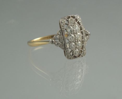 18CT GOLD AND DIAMOND ART DECO RING. The rectangular openwork mount milligram set with a group of eight old cut diamonds with